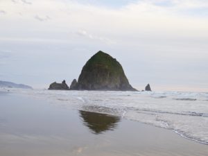 empty sandy ocean beach and haystack rock